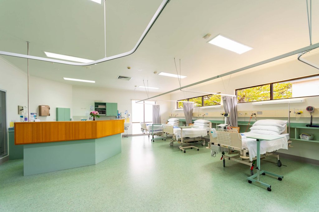 Clean modern hospital ward and nurse's desk